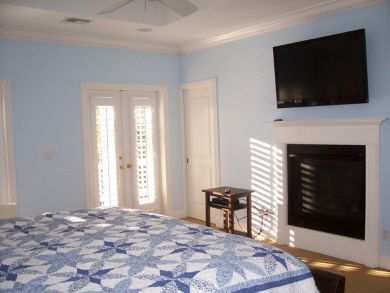 Master bedroom with flat screen TV & fireplace