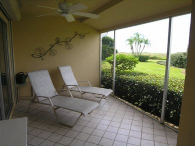 Screened porch with lounging chairs