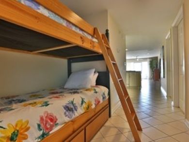 One set of twin bunk beds with trundle in hallway