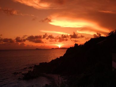 Sun falls with a blaze of color into the Caribbean Sea in winter
