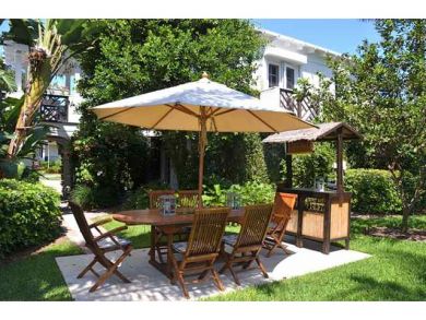 Outdoor table set surrounded by landscaped gardens Outdoor table set surrounded by landscaped gardens
