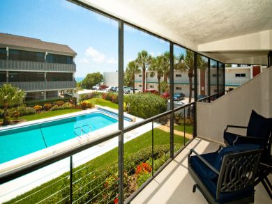 Screened balcony with outdoor chairs