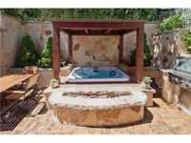 Backyard with hot tub, fire pit & BBQ grill Backyard with hot tub, fire pit & BBQ grill