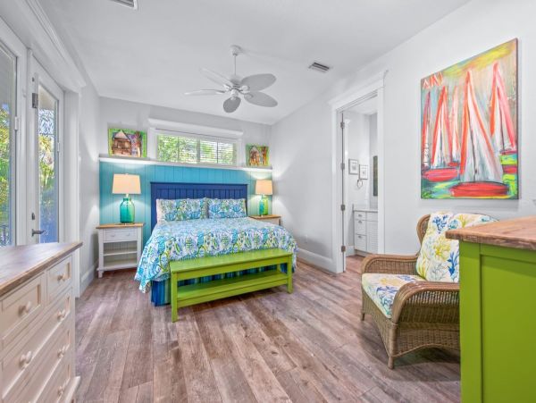 Main floor- Master bedroom with king bed and French doors to pool area