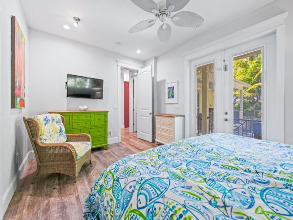 Main floor- Master bedroom with king bed and French doors to pool area