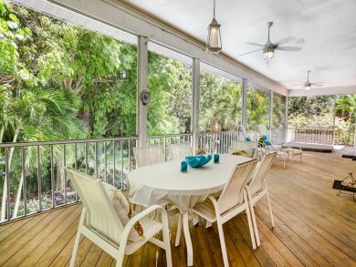 large deck with table chairs for dining