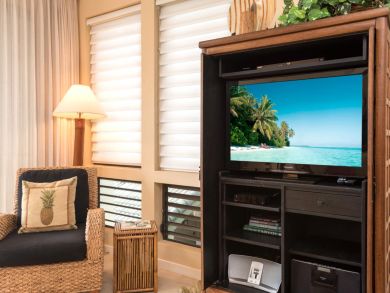 Television next to side chair in living room