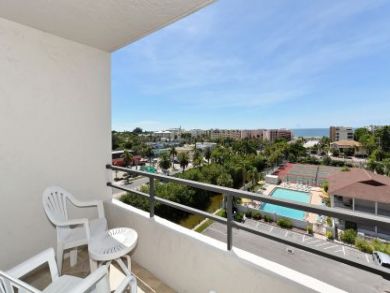 Patio Chairs on Balcony with Pool View