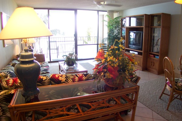 Living room with TV & open to balcony