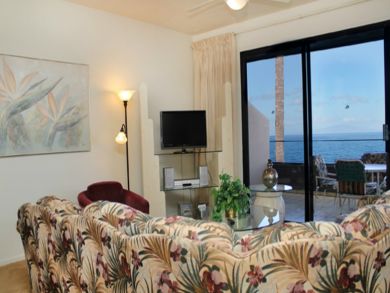 Living room with TV & open to balcony
