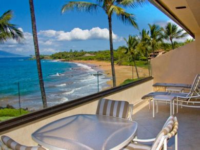 Ocean view balcony with table set & lounging chairs
