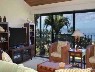 Living room with large flat screen TV & full ocean view