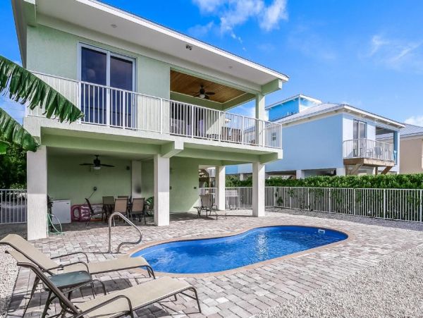 Waterfront 4 Bedroom Home with Pool Dock & View of Canal