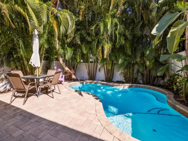 Remodeled Duplex with private pool 1/2 block to beach with a Golf Cart