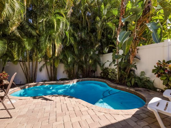 Remodeled Duplex with private pool 1/2 block to beach with a Golf Cart
