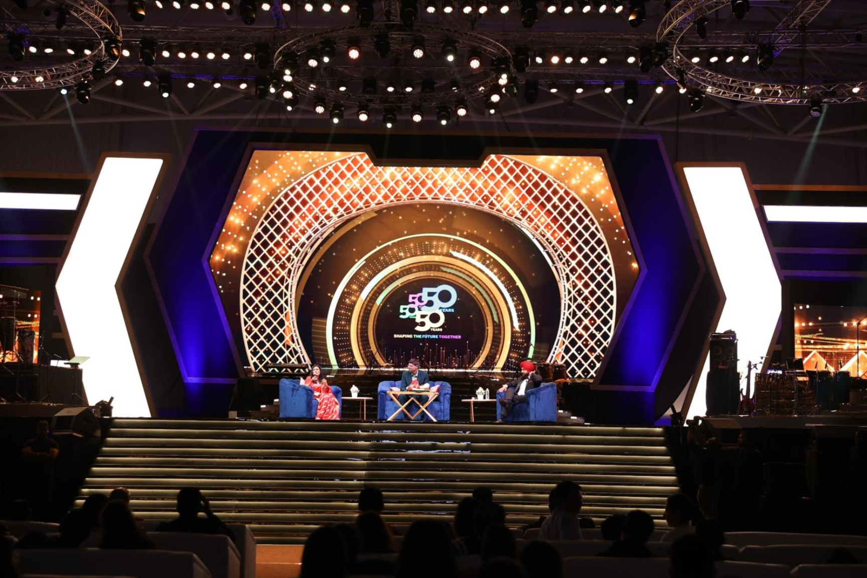 A stage with lights and people on itAI-generated content may be incorrect.