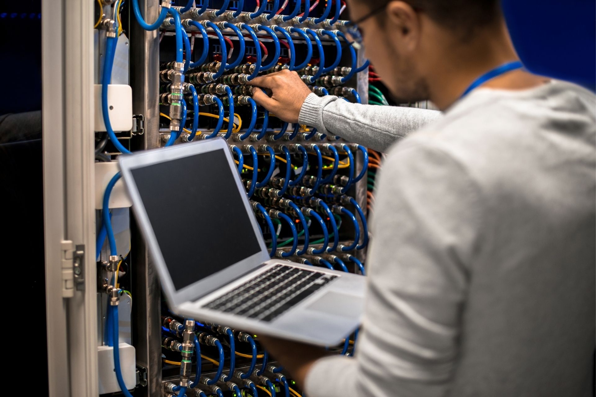 What tools and equipment are recommended for safely routing fiber optic cables through tight spaces or conduits?