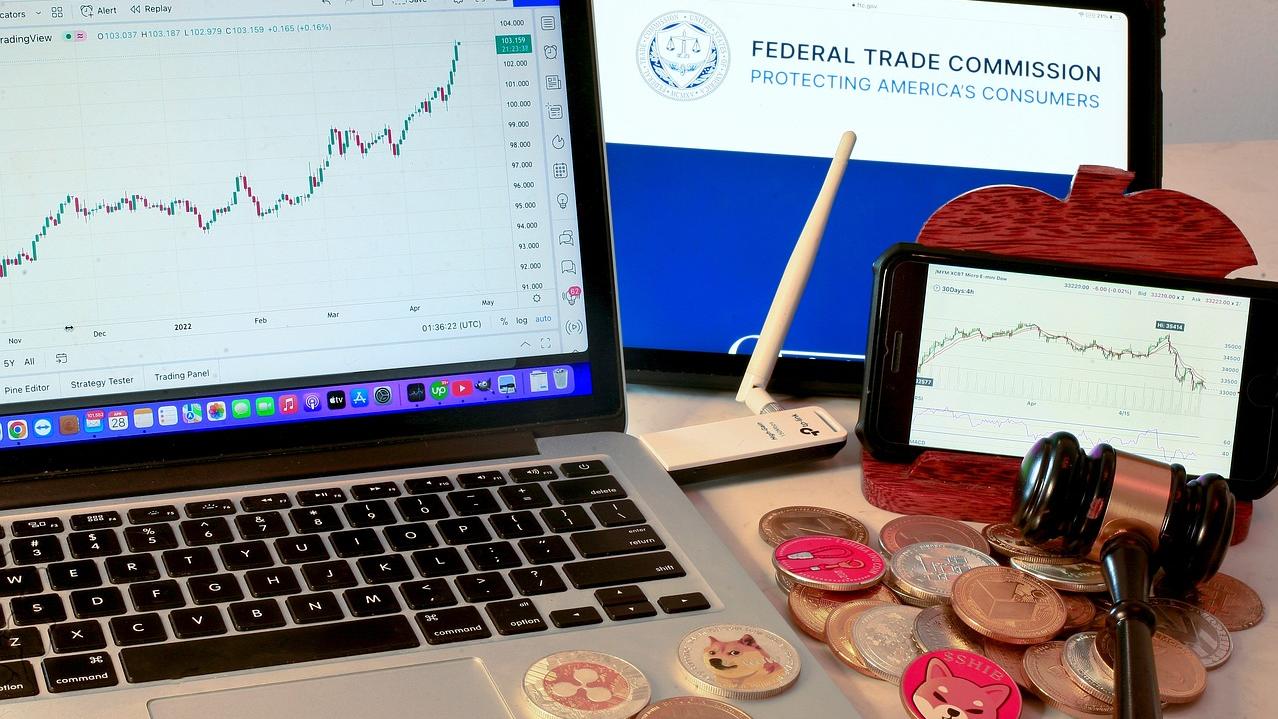 Electronic screens display economic charts and the logo for the Federal Trade Commission