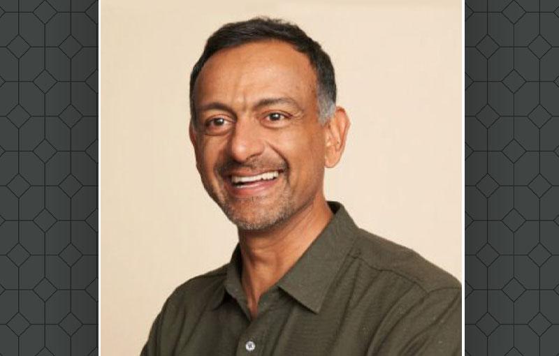 Headshot of Paul Grewal over top of a gray lattice pattern