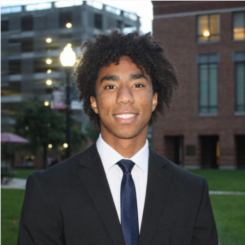 Julian wearing a suit and smiling