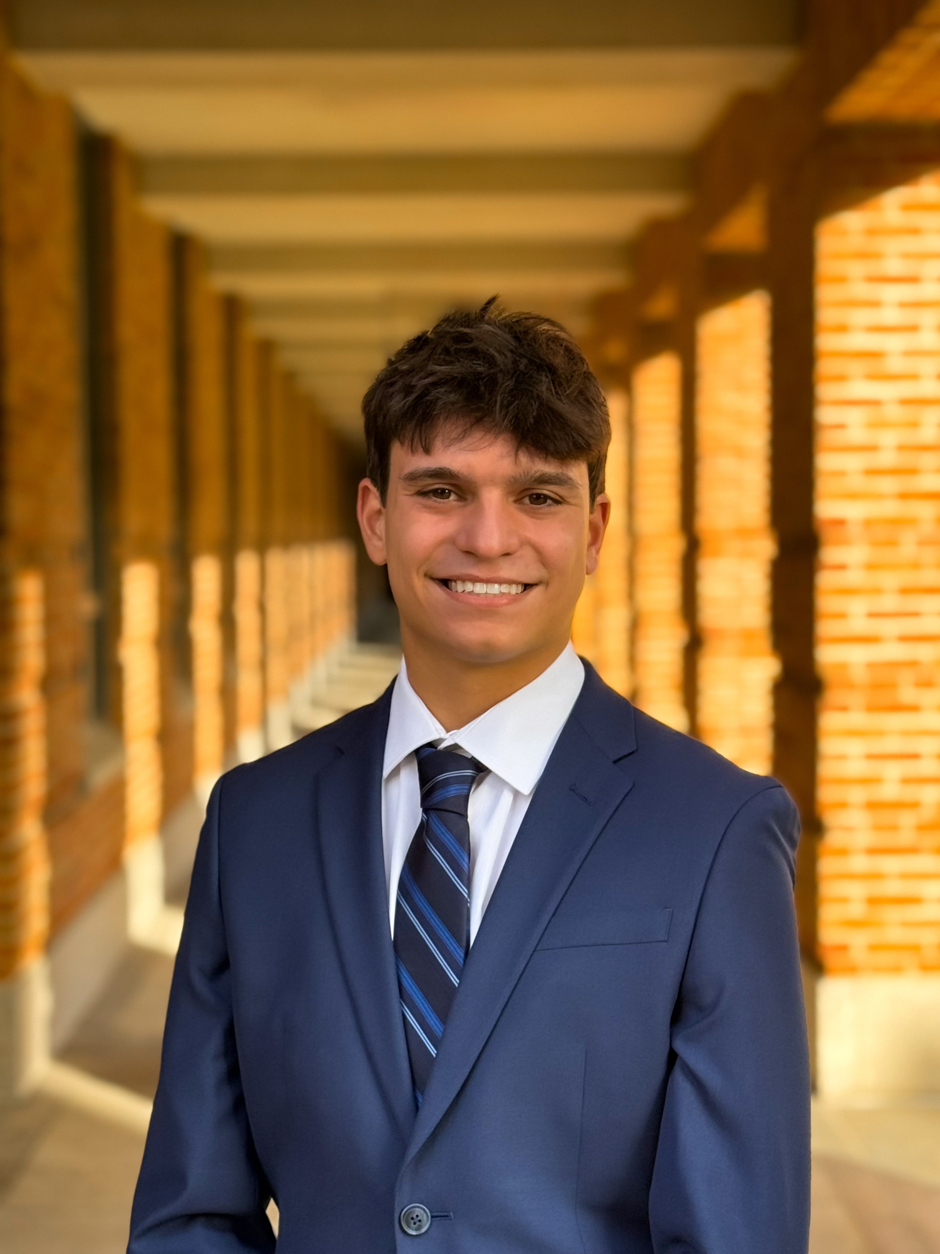 Man smiling at the camera while wearing a blue tux 