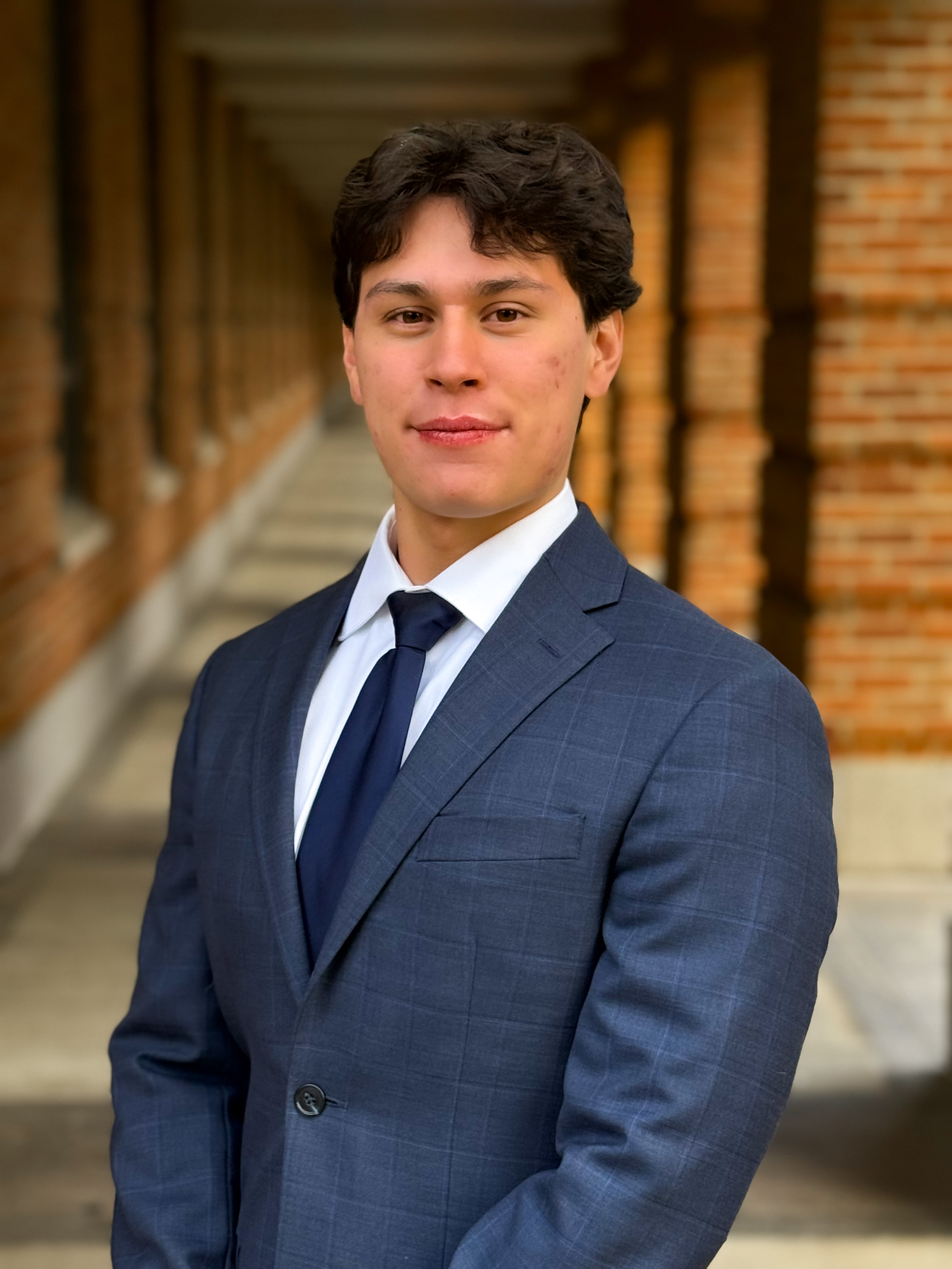 man looking at camera with navy blue suit