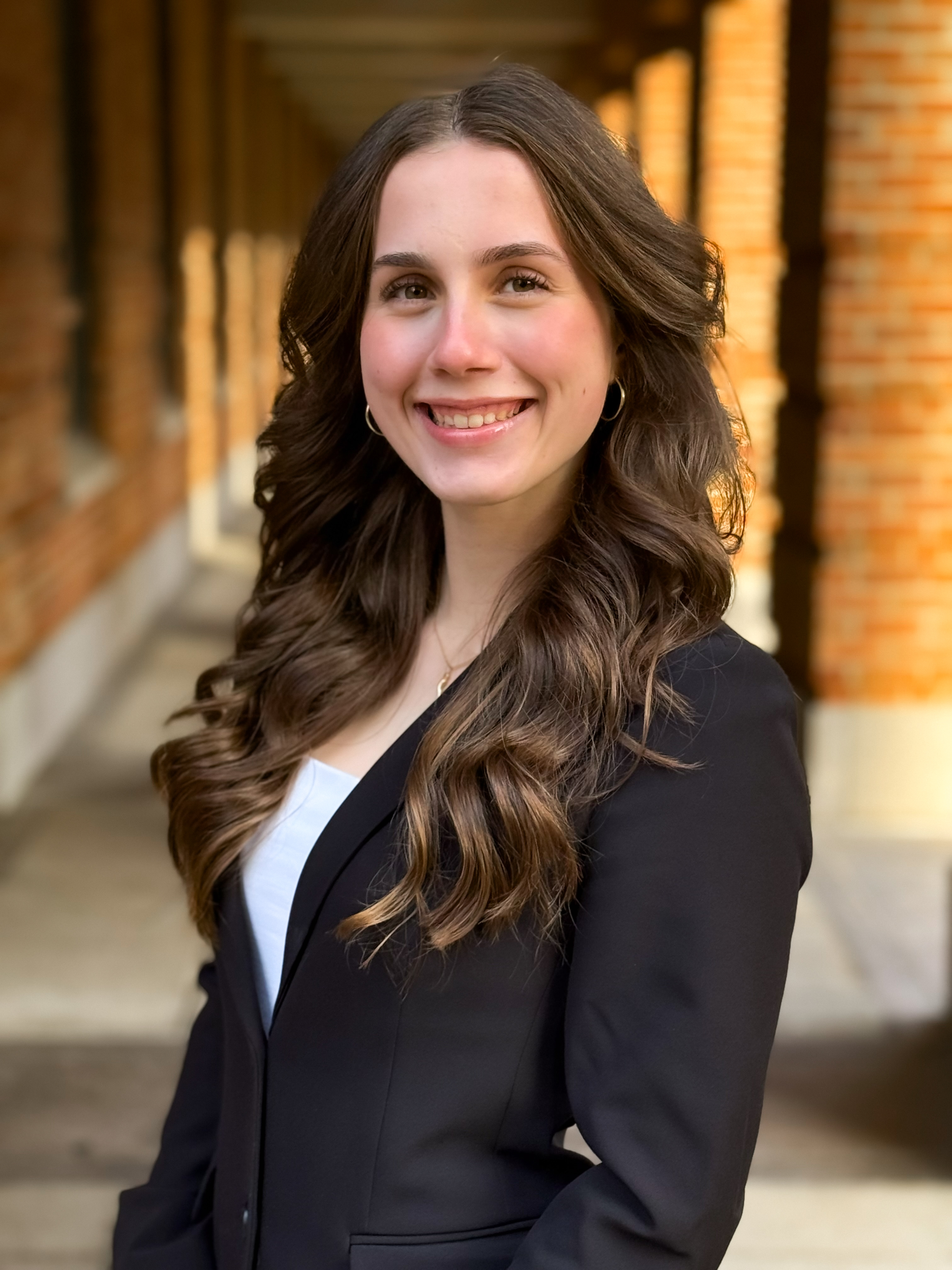woman smiling at the camera with a black suit jacket