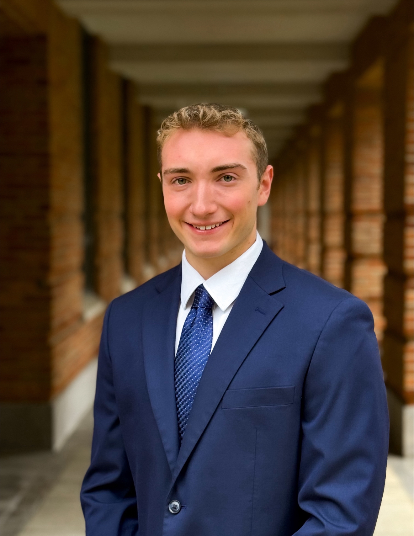 man smiling at the camera with a blue tux and blue tie