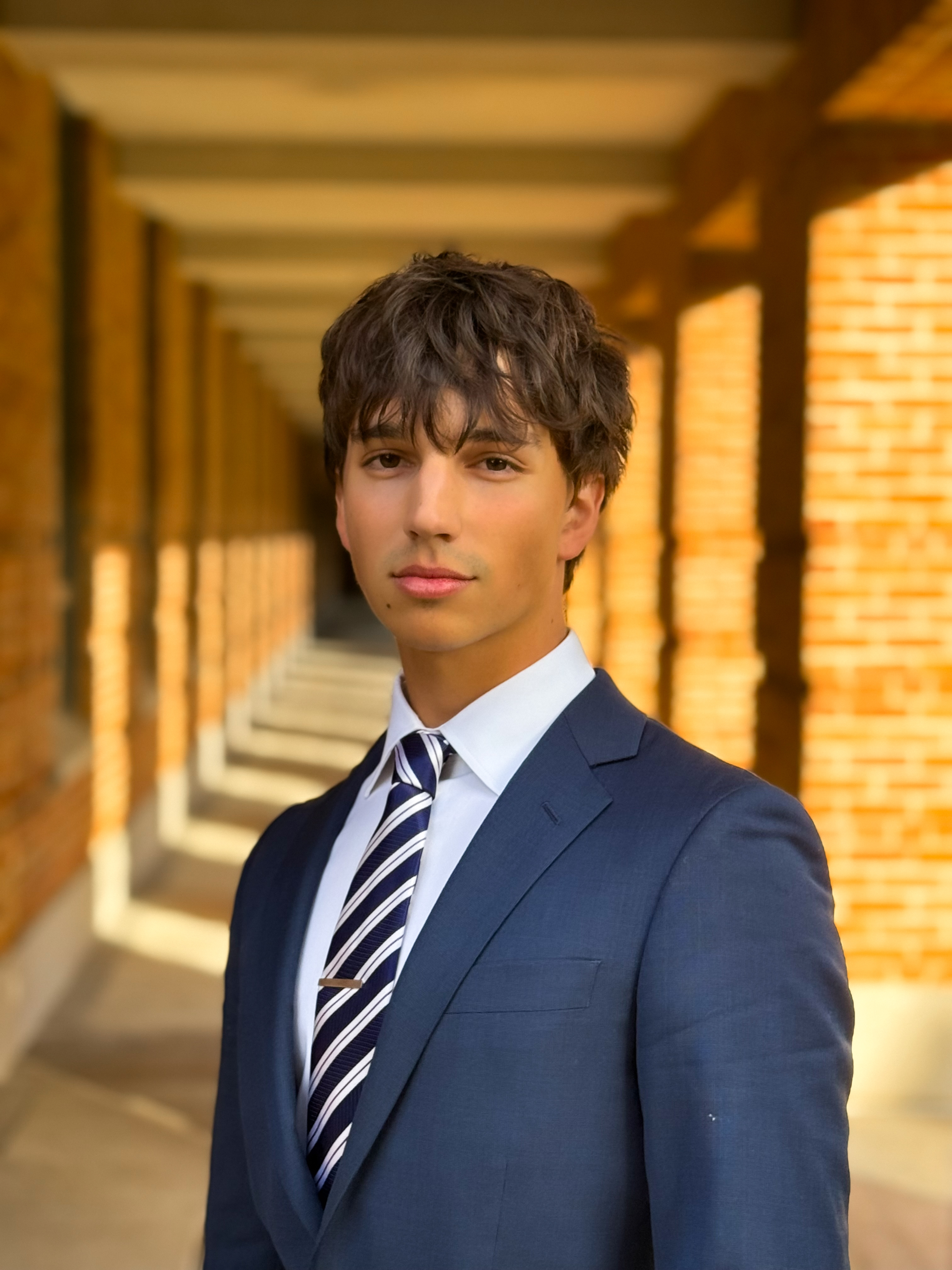 man looking at camera with navy blue suit