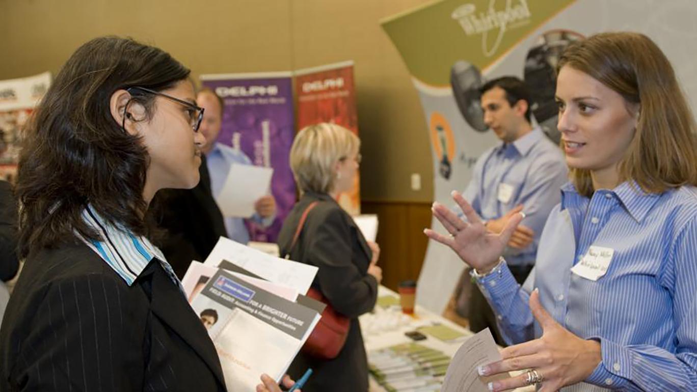 A student speaking with a recruiter at a job fair