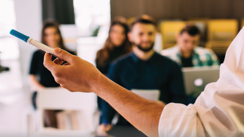 Someone presenting to a classroom of emerging leaders
