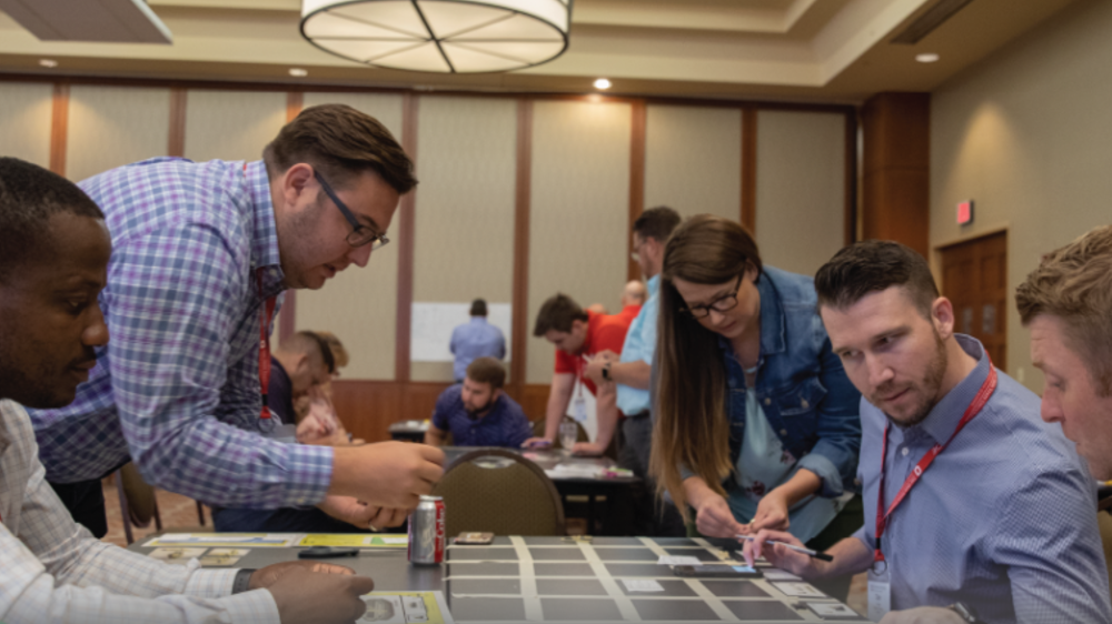 5 people in a classroom participating in an operational excellence activity