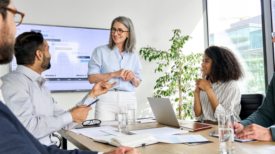 5 business leaders talking in conference room