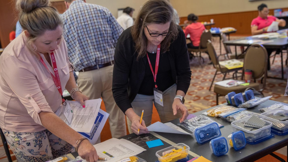 2 women participating in a Lean Six Sigma activity