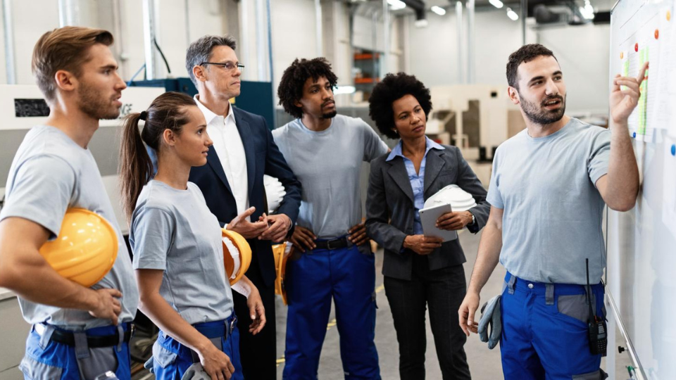 6 people meeting in a manufacturing facility