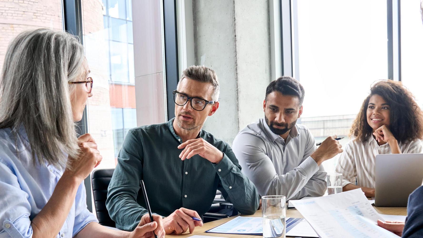4 executives meeting in a conference room