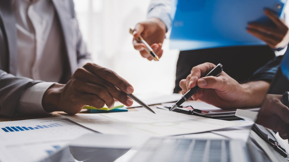 3 businesspeople reviewing metrics