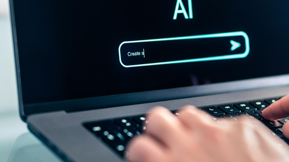 Hands on a keyboard preparing to type a prompt into an AI platform