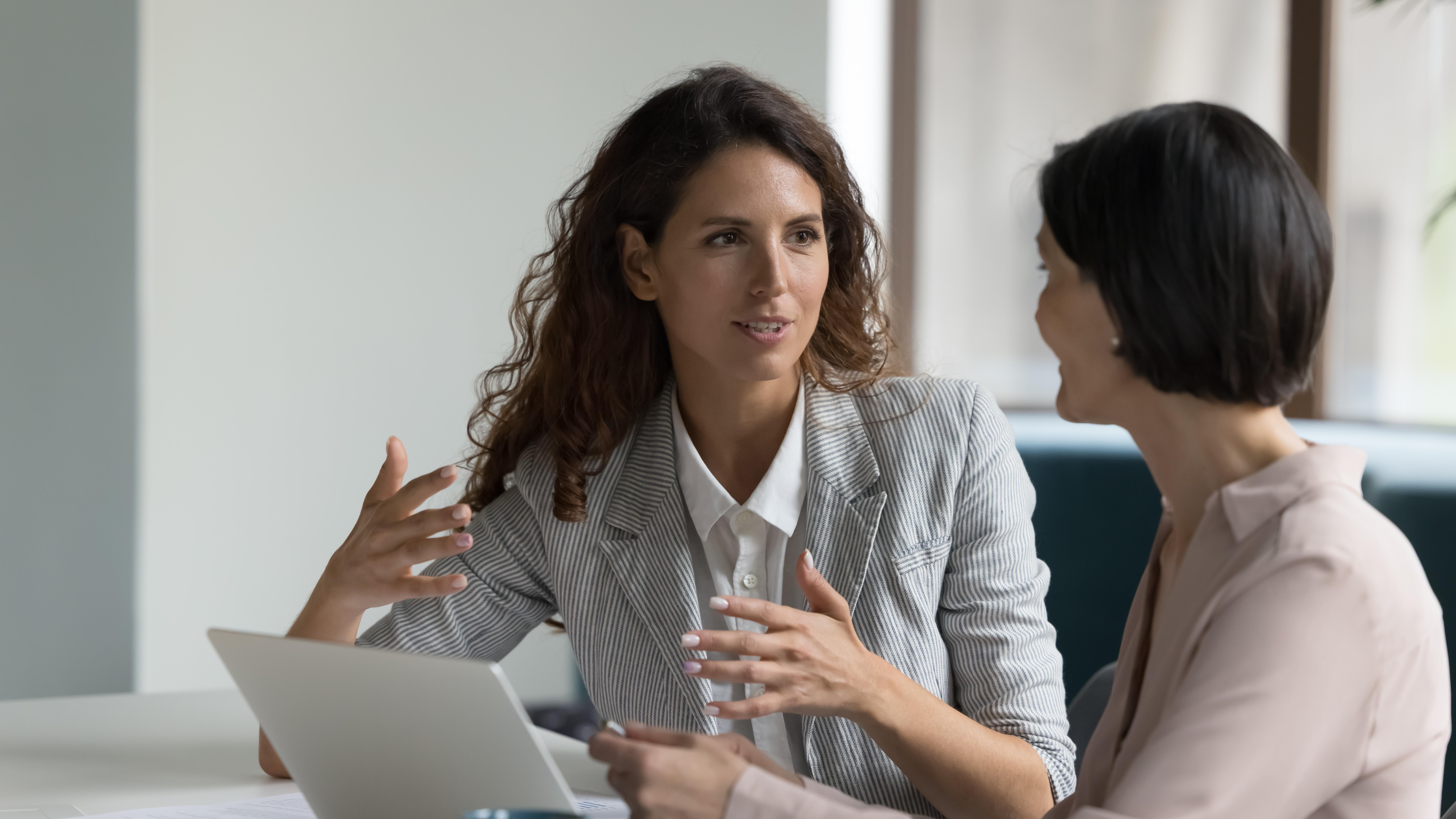Two businesswomen having a discussion in an office