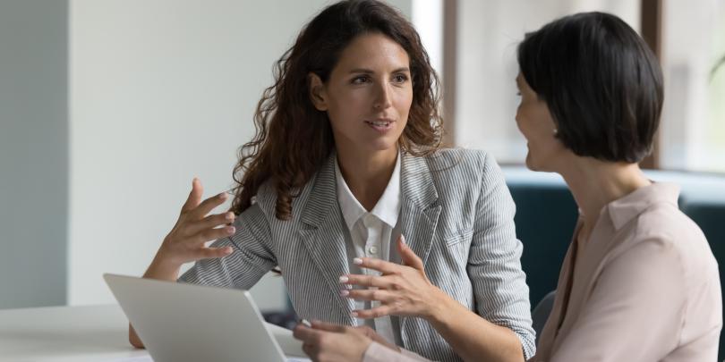 Two businesswomen having a discussion in an office
