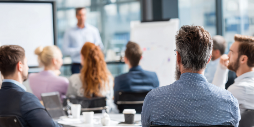 A group of people listening to a speaker