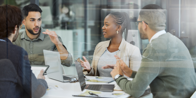 a group of professionals speaking around a table