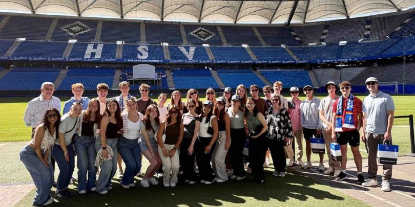 Group of students inside soccer stadium in Germany