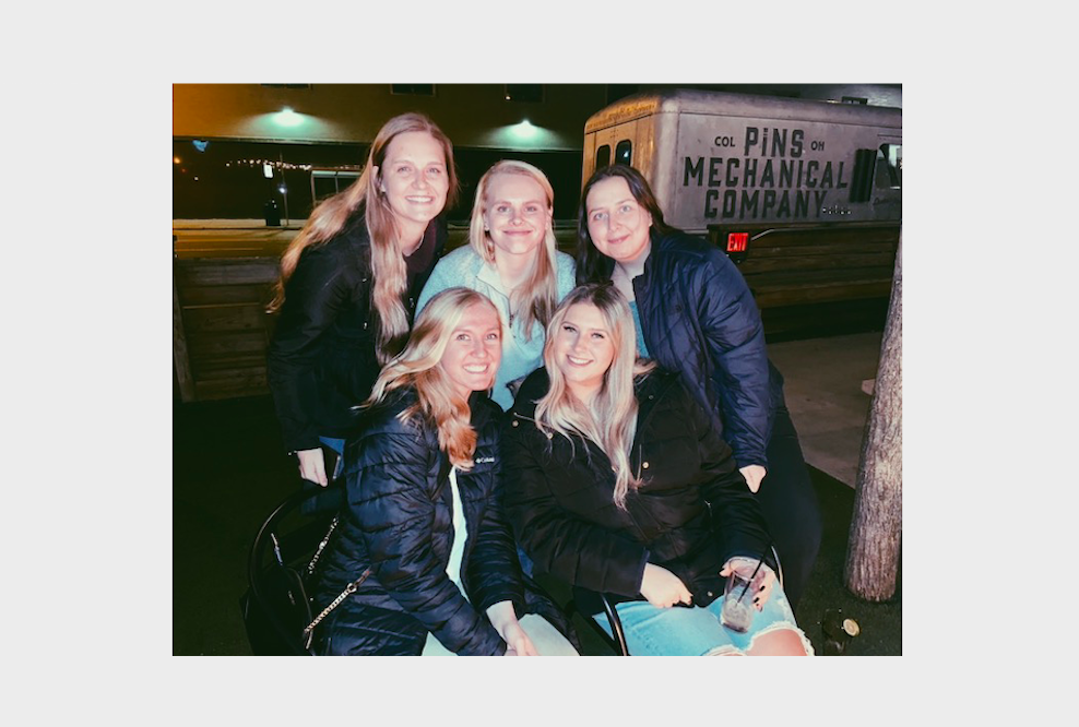 Photo of five girls sitting outside at Pins Mechanical Company