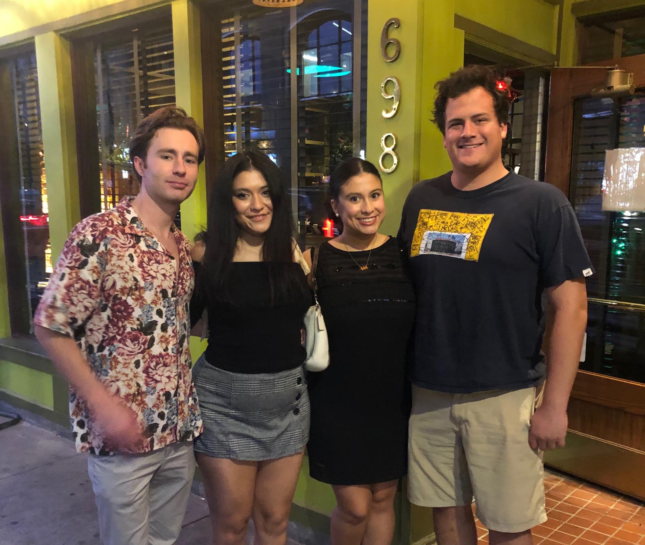 Photo of two couples together in front of a restaurant 