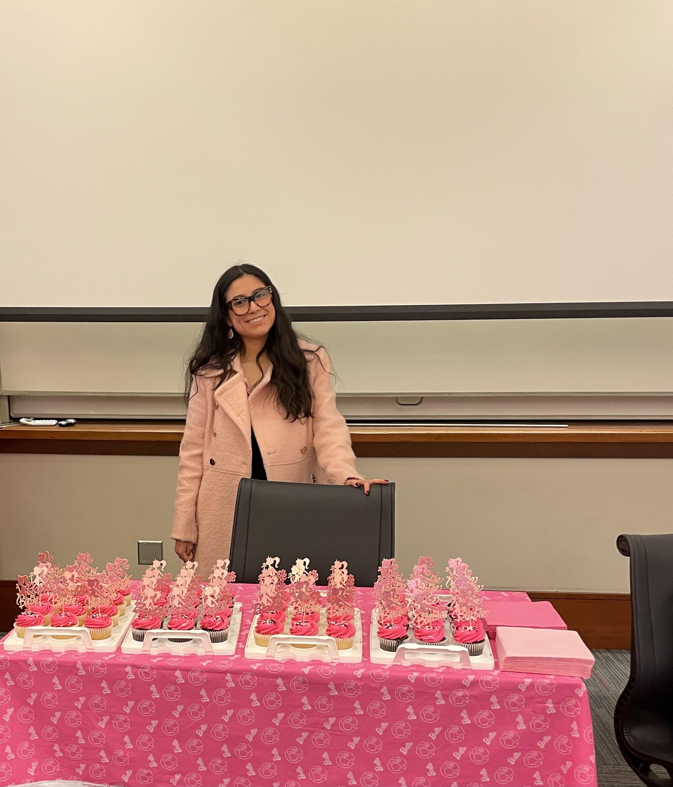 Woman smiling behind a desk
