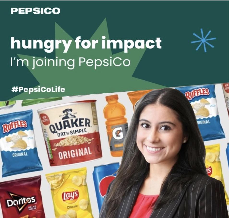 Woman smiling in front of bags of chips