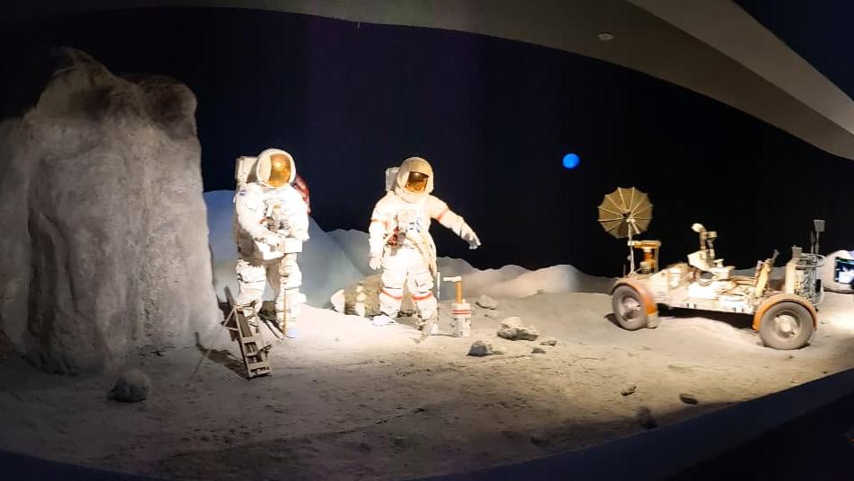 Astronaut and Moon rover on the surface of moon 