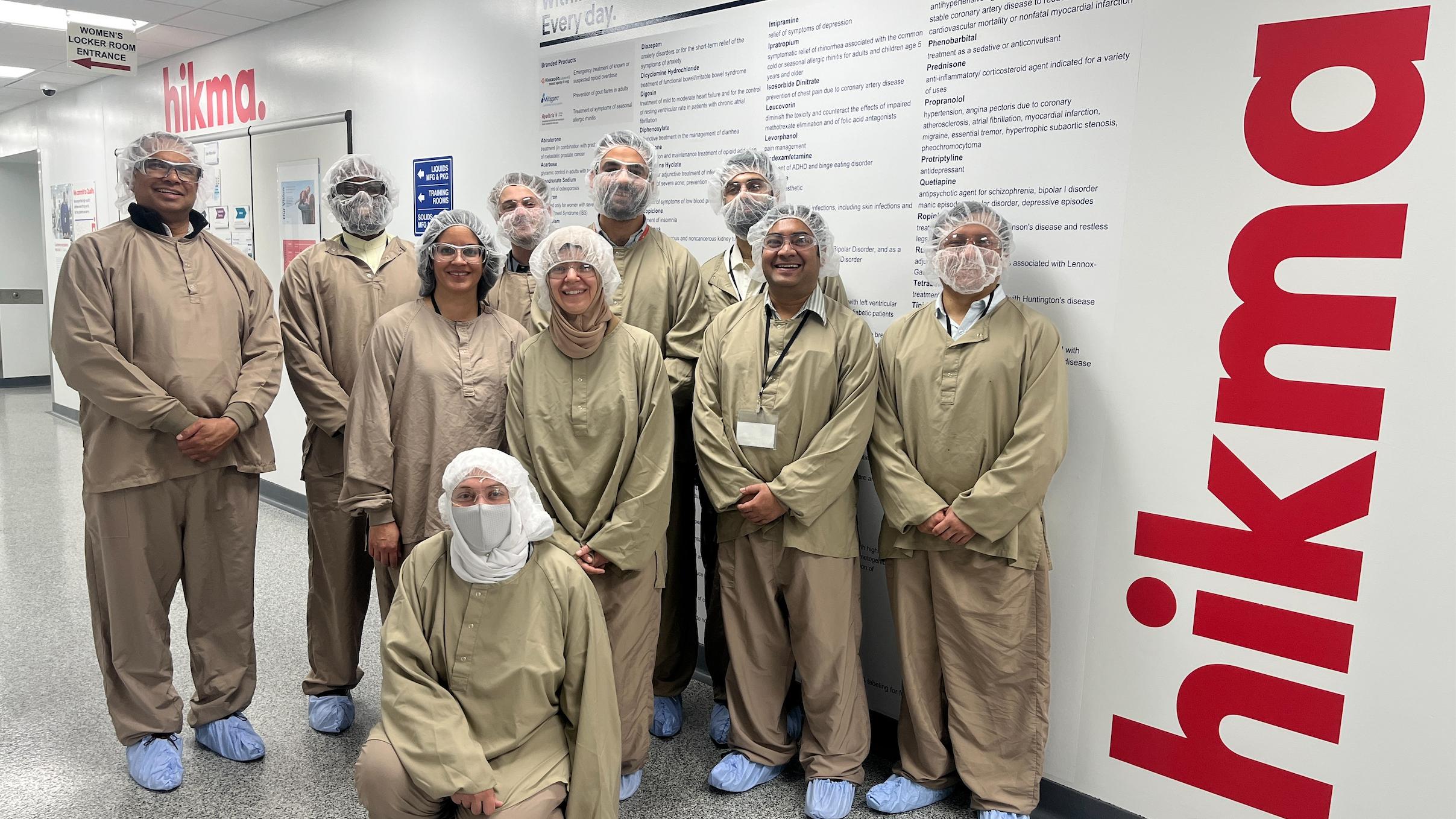 People fully clothed in special clothes in a pharmaceutical company