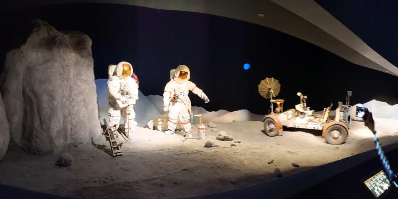 Astronaut and Moon rover on the surface of moon 